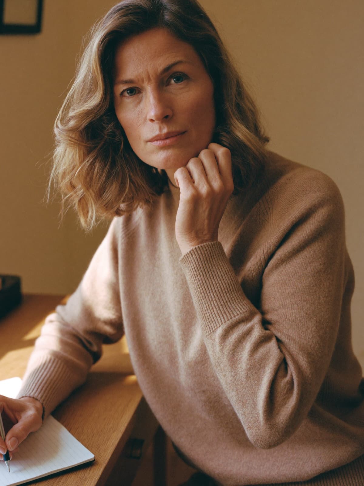 Woman focused and clear-headed at a sunlit desk