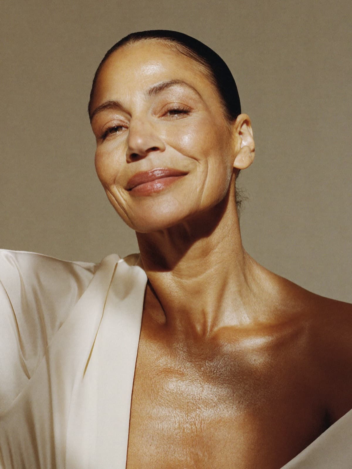 Woman with clear, healthy skin in warm window light