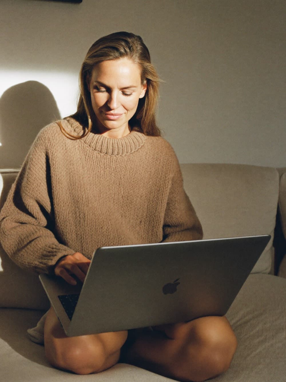 Woman completing an online intake on her laptop
